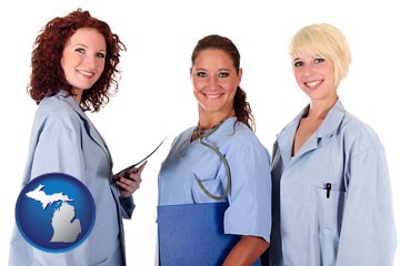three female doctors wearing hospital uniforms - with Michigan icon