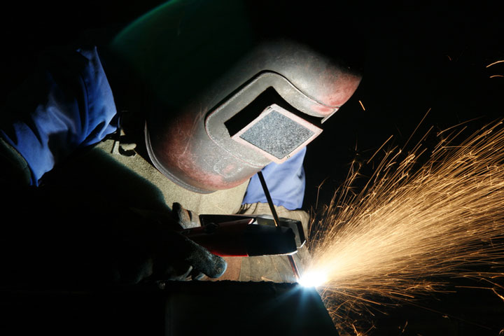 a welder using welding equipment (large image)