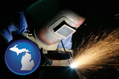 michigan map icon and a welder using welding equipment