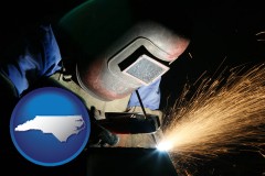 north-carolina map icon and a welder using welding equipment
