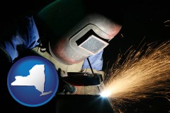 new-york map icon and a welder using welding equipment