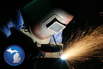 a welder using welding equipment - with Michigan icon