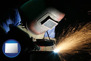a welder using welding equipment - with Wyoming icon