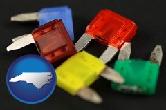 north-carolina map icon and colorful automobile fuses