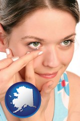 alaska map icon and a young woman inserting a contact lens