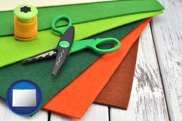 craft supplies (colorful felt and a pair of scissors) - with Colorado icon