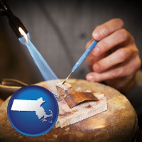 massachusetts map icon and a goldsmith making a custom gold ring