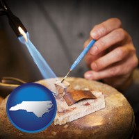 north-carolina map icon and a goldsmith making a custom gold ring