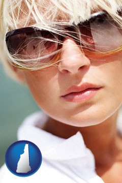 a young woman wearing sunglasses - with New Hampshire icon