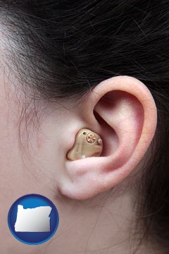 a woman wearing a hearing aid in her left ear - with Oregon icon