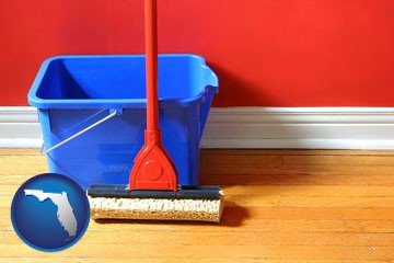 a bucket and mop on a hardwood floor - with Florida icon