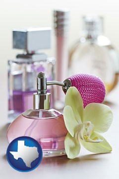 a perfume bottle, with atomizer, and an orchid flower - with Texas icon