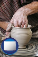 wyoming map icon and a potter making pottery on a pottery wheel