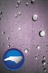 north-carolina map icon and water droplets on a shower door