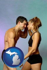 michigan map icon and a couple wearing black swimsuits