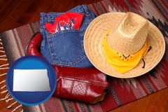 north-dakota map icon and western boots, hat, and jeans